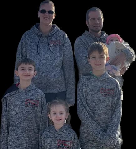 The Yoder family wearing Yoder's Roofing Service shirts